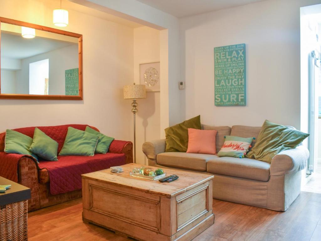 a living room with a couch and a coffee table at Beachcroft in Bournemouth