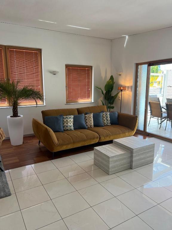 a living room with a brown couch and a table at Vacation home Oxy in Ferlach