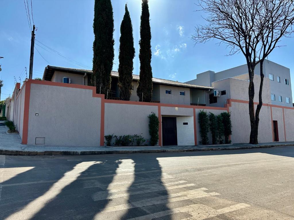 a building with trees on the side of a street at Pousada Paraiso in Paracatu
