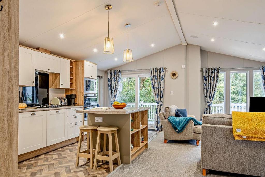 a kitchen and living room with a couch and a table at St Helens Beach Retreat in Saint Helens