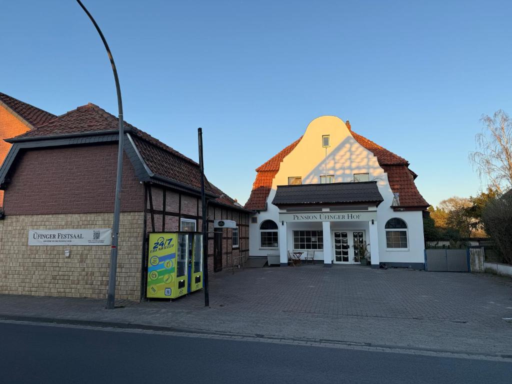 a building with a turret on the side of a street at Pension Üfinger Hof in Salzgitter