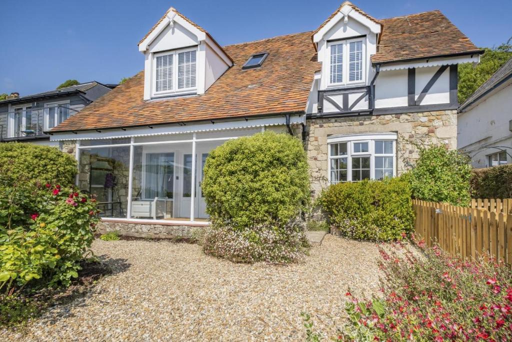 a house with a garden in front of it at Woodstock in Ventnor