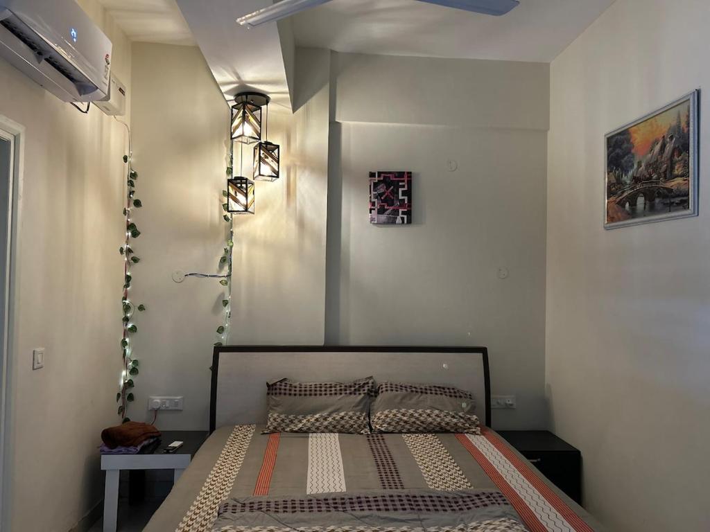 a bedroom with a bed in a room at Nivaas Cozy 1BHK Stay near Airport Road in Zirakpur