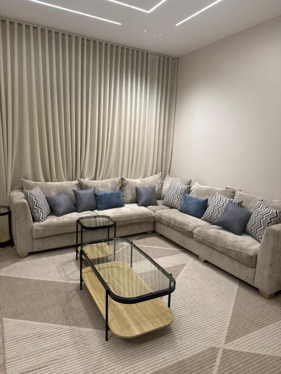 a living room with a couch and a coffee table at المنزل الآمن in Medina