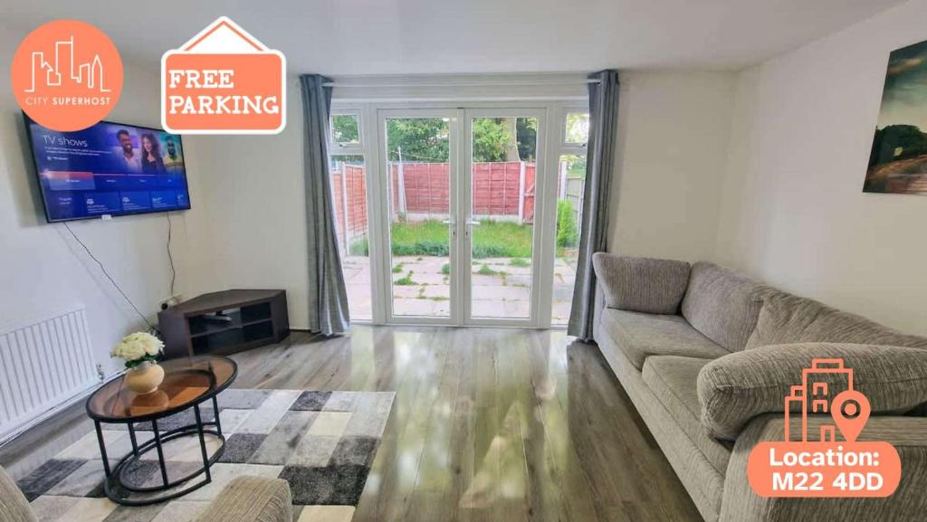 a living room with a couch and a table at 3 Bedroom Northenden Home by City SuperHost in Wythenshawe