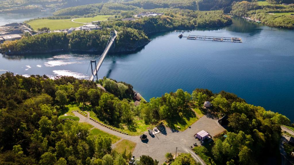 an aerial view of a lake with a windmill at NorGlamp Glamping in Hjelmeland