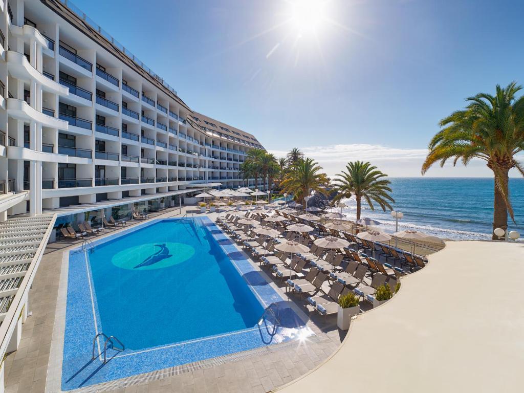 a hotel with a swimming pool next to the beach at Don Gregory by Dunas - Adults Only in San Agustin