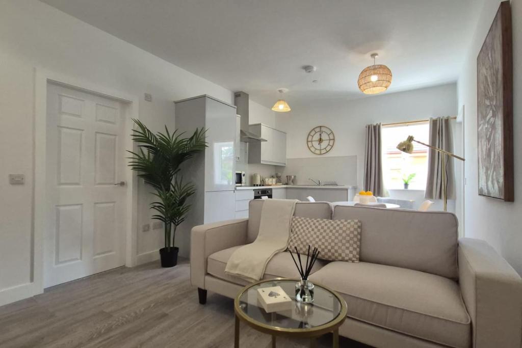 a living room with a couch and a table at Flat 8, Cupar Apartments. in Fife