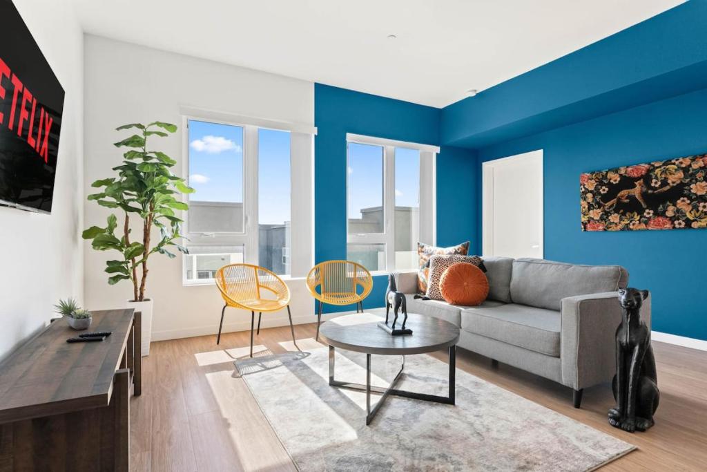 a living room with blue walls and a couch and chairs at Little Tokyo Gem, Steps from Shops with Free Parking in Los Angeles