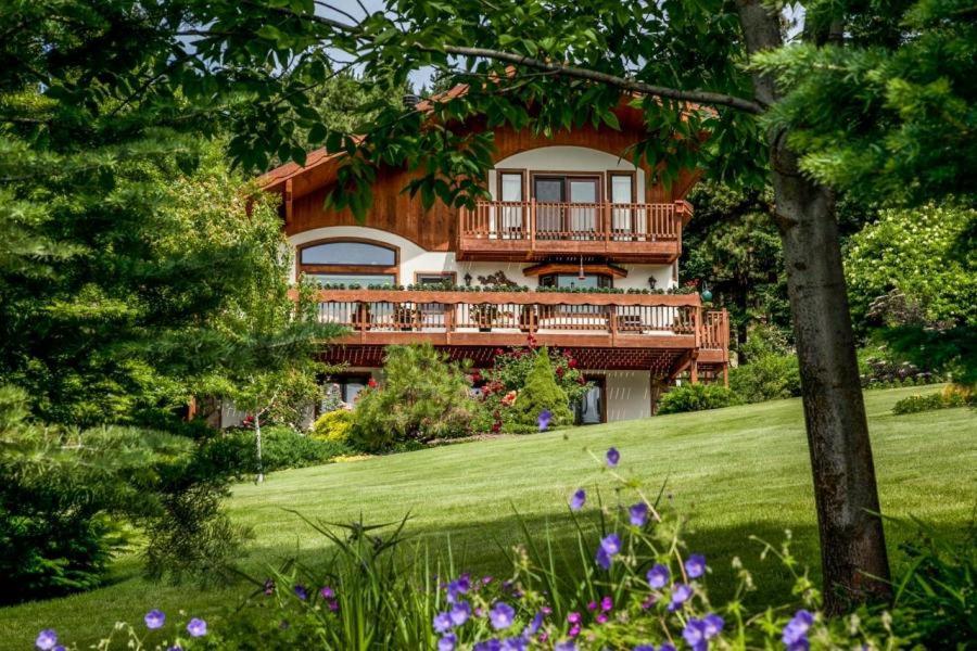 a large house with a deck on the side of it at Fox Den Bed & Breakfast in Leavenworth