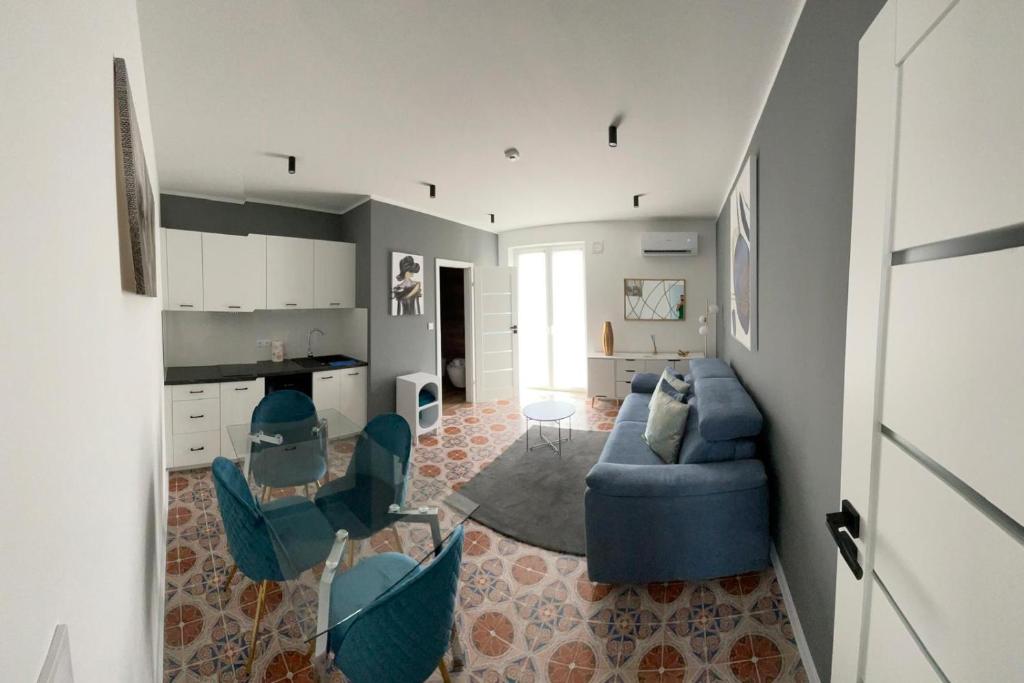 a living room with a blue couch and chairs at Vento di Sicilia in Carini
