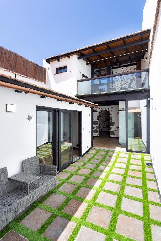 an internal view of a house with a patio and grass at Home2Book Rustic Stone Haven with Terrace in La Guancha