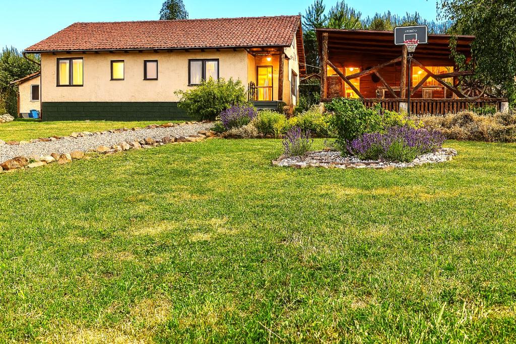 a house with a basketball hoop in the yard at Bellevue Beam House in Covasna