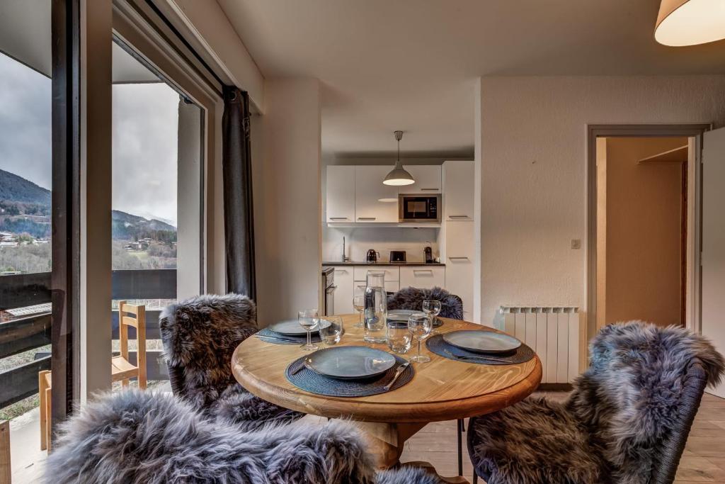 a dining room with a wooden table and chairs at Apartment with balconies at the foot of the slopes in Les Houches