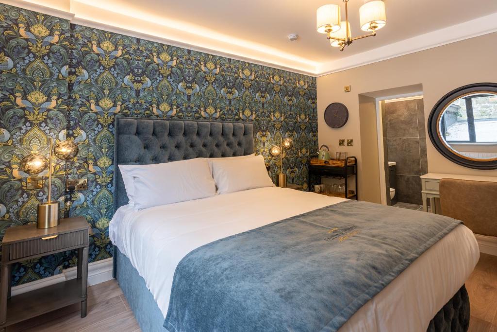 a bedroom with a bed with a blue and gold wallpaper at No 5 Rose Inn Street - Room 2 in Kilkenny