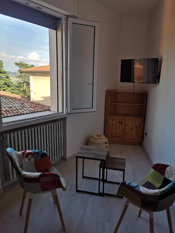 a living room with two chairs and a tv at Il Rifugio di Mario in Monzuno