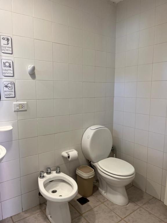 a bathroom with a toilet and a sink at Los Lupinos in El Calafate