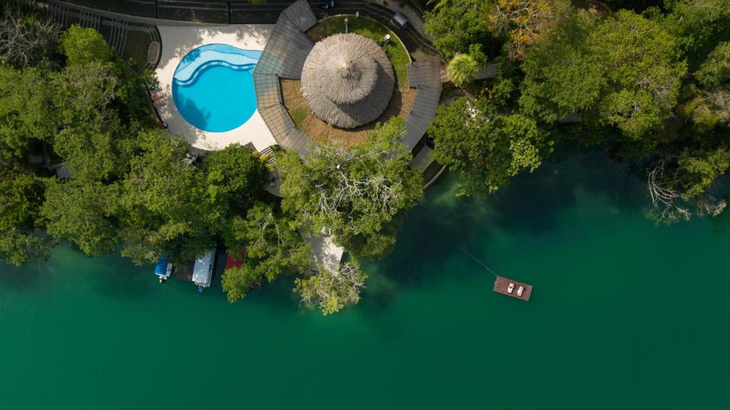 an overhead view of a lake with trees and a building at Bolontiku Boutique Hotel Member of the Cayuga Collection in Flores