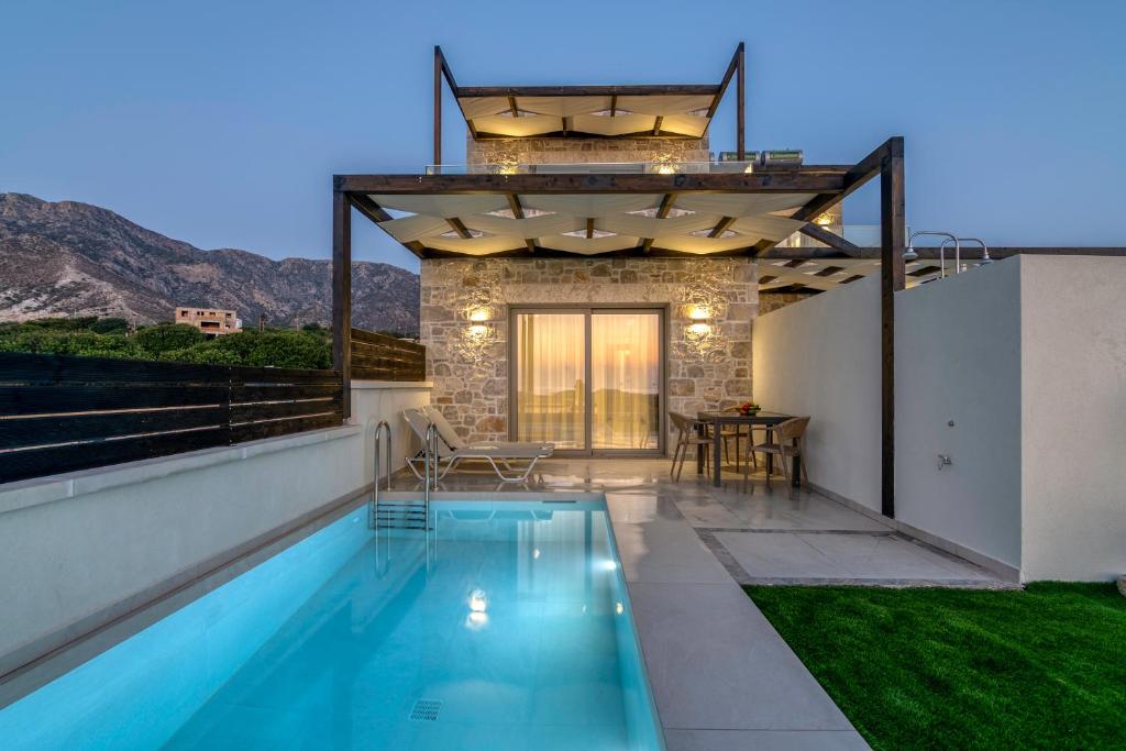 a villa with a swimming pool and a house at Elafonisi Pearl in Elafonisi
