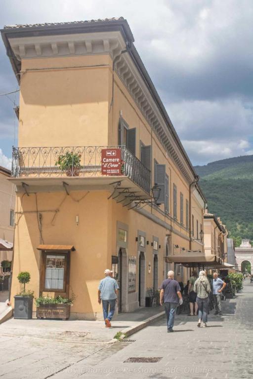 a group of people walking down a street in front of a building at Il corso in Norcia