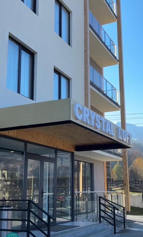 a building with a sign for a gym rental lot at Bakuriani Crystal Loft Apt in Bakuriani
