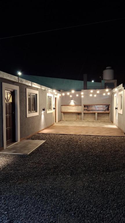 a building with a bench and lights on it at night at Cabañas Gadiel in San José de las Salinas