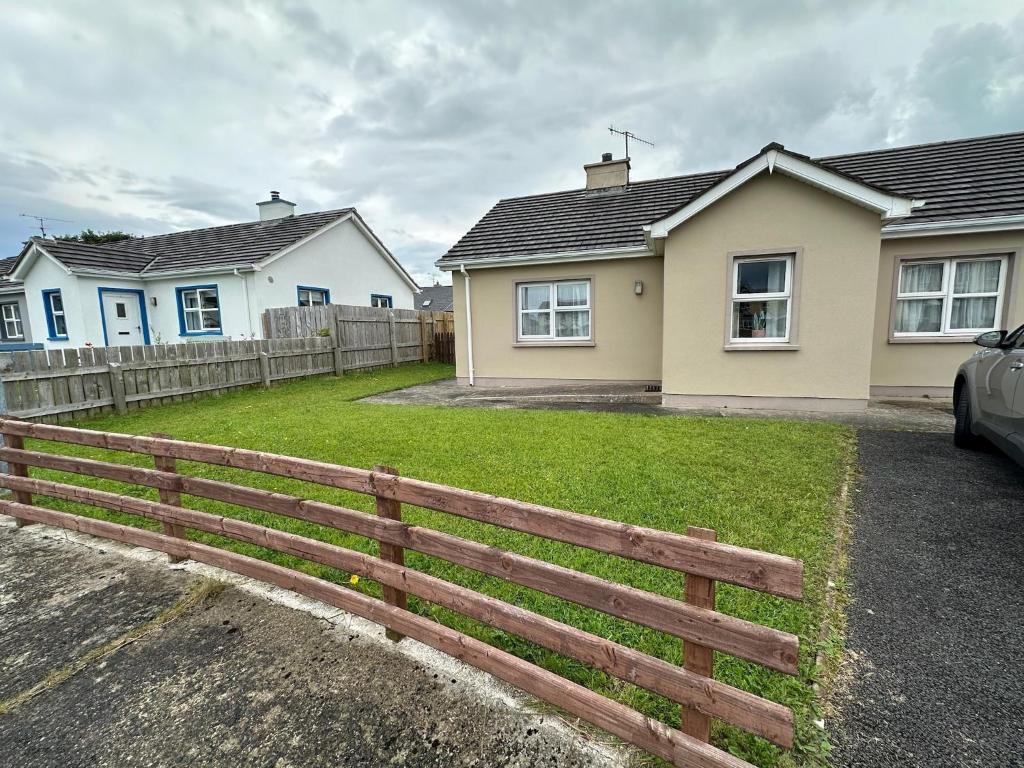 a house with a fence in front of it at A home in Bundoran in Bundoran