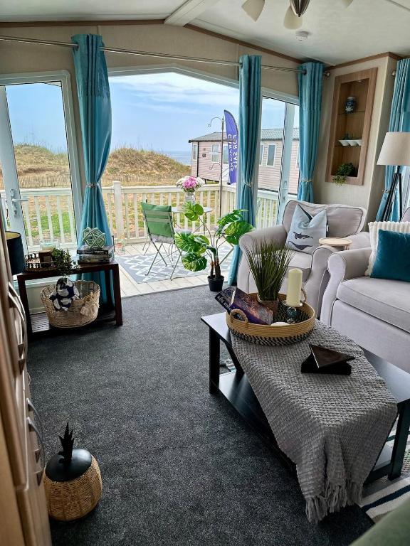 a living room with a couch and a table at Celebration by the sea in Redcar