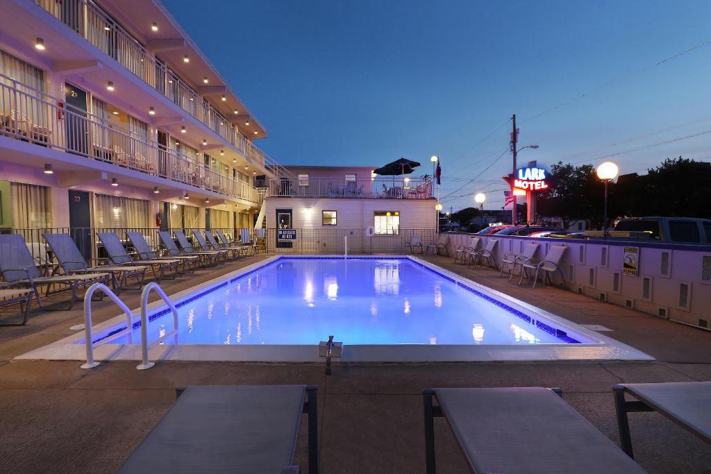 a large swimming pool in front of a hotel at Lark Motel in Stone Harbor