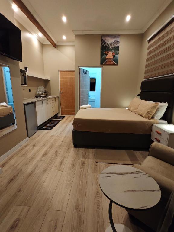 a bedroom with a bed and a living room at ARCHITECT's VIEW SUITE 1 in Durban
