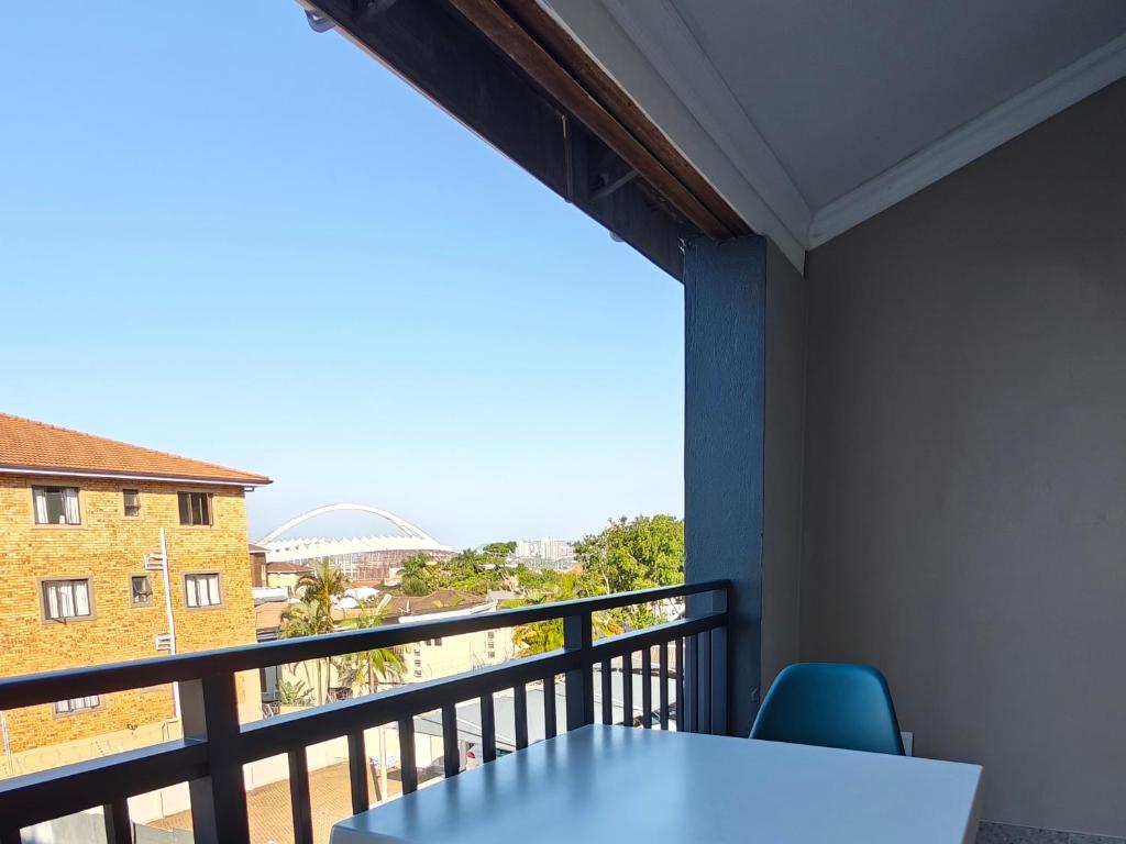 a room with a balcony with a table and chairs at ARCHITECT's VIEW SUITE 1 in Durban