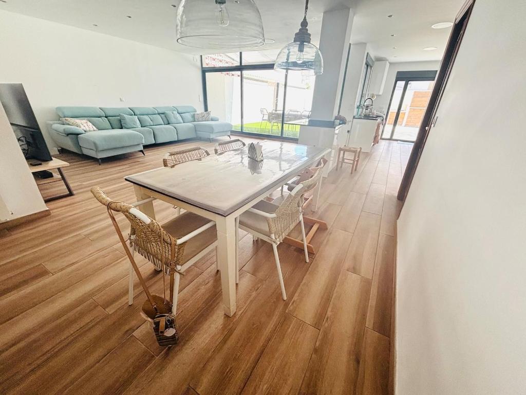 einen weißen Tisch und Stühle im Wohnzimmer in der Unterkunft Casa con PISCINA y CINE in Paterna