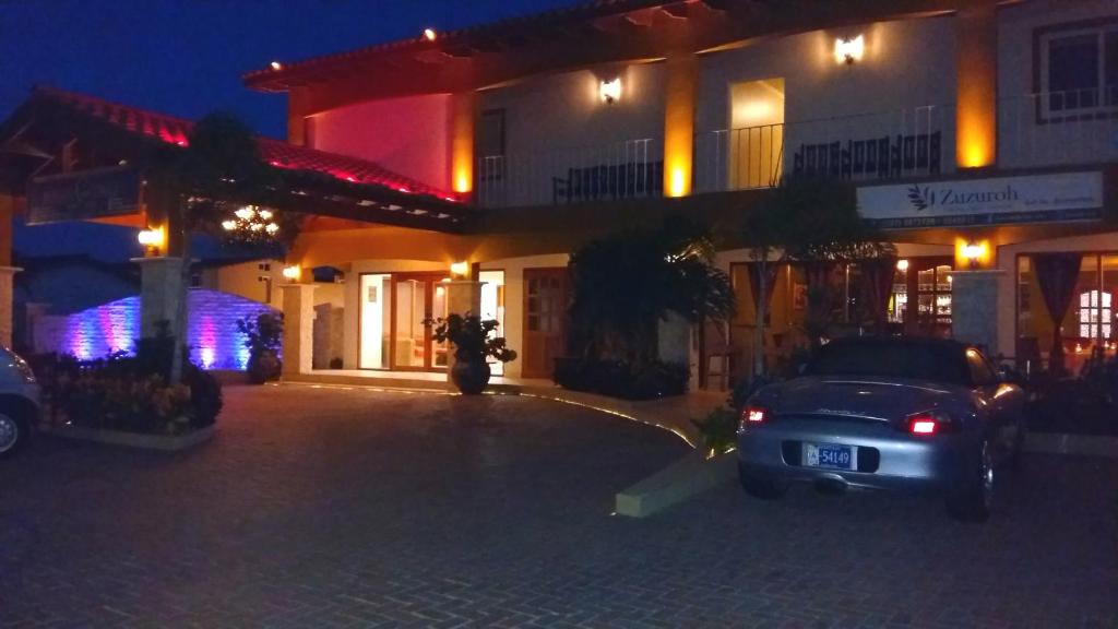 a car parked in front of a building at night at Dorado Eagle Beach Hotel in Palm-Eagle Beach