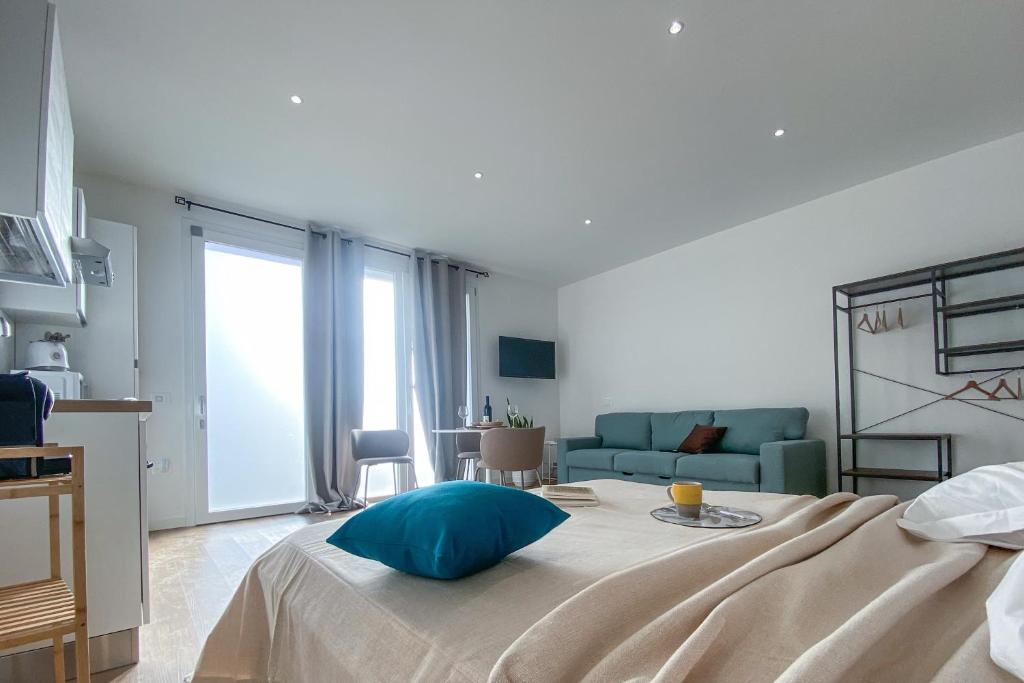 a bedroom with a bed with a blue pillow on it at SolVerdi in Oristano