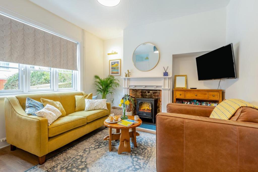 a living room with two couches and a tv at Little Hamilton - Wimborne in Wimborne Minster