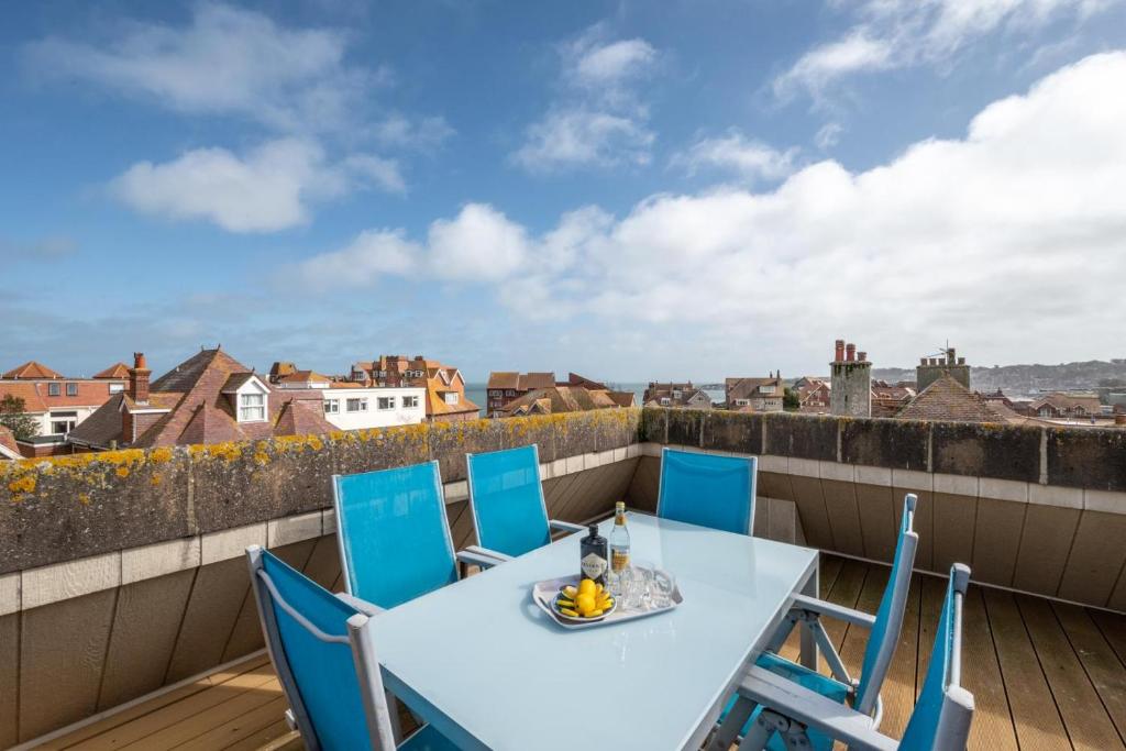 a table and chairs on a balcony with a view at Flat 9 Broadleys in Swanage