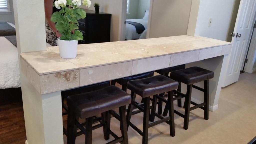 a kitchen island with a counter and stools at Trees Motel in Bishop