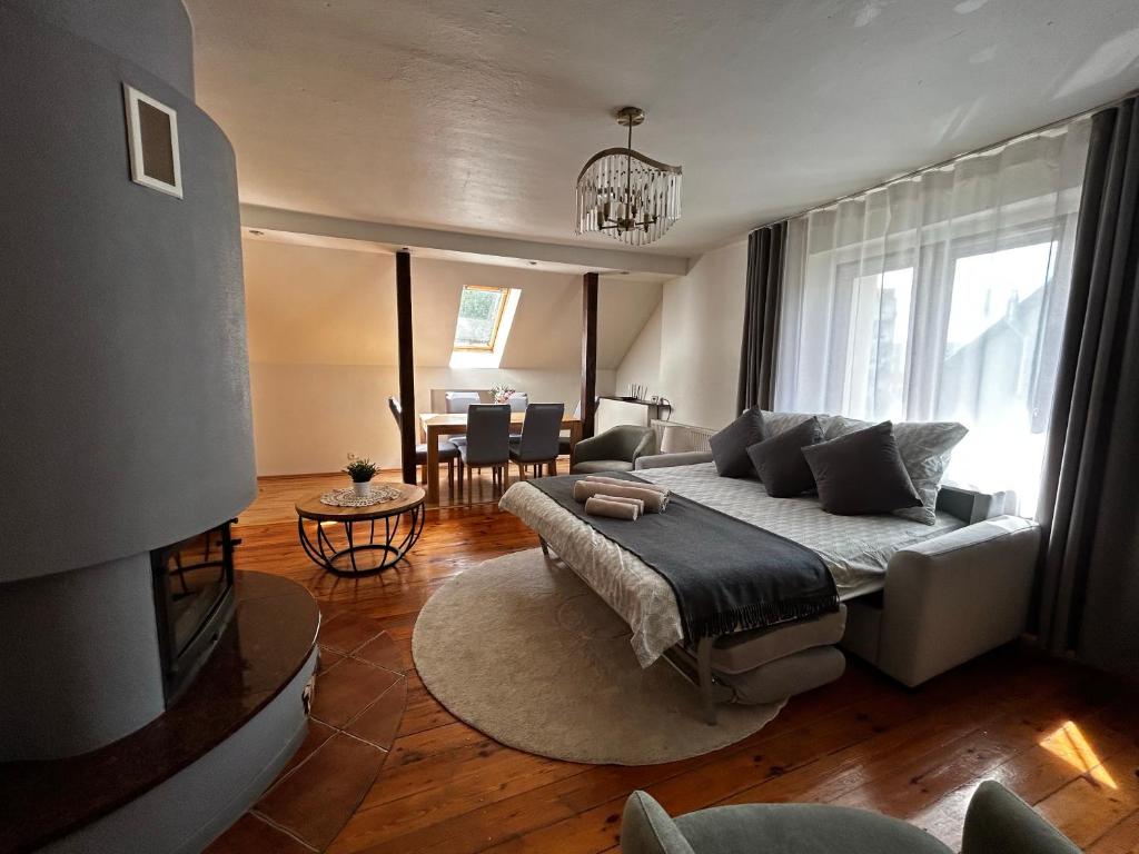 a living room with a couch and a tv at Słupiecki Zakątek in Nowa Ruda