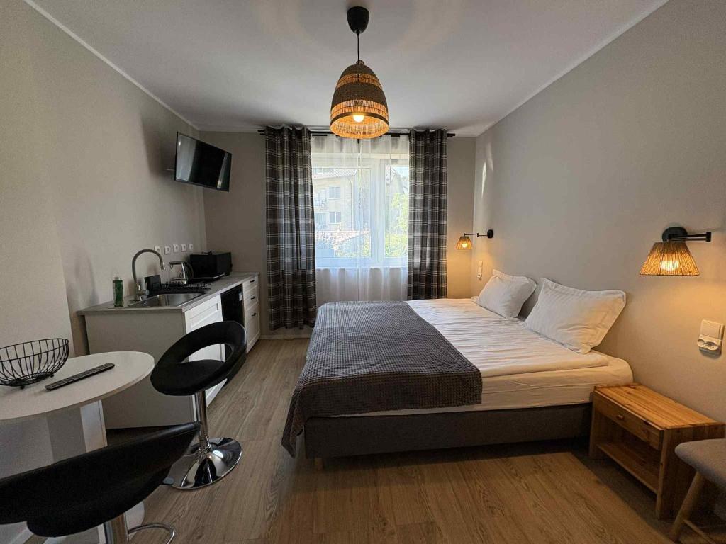 a small bedroom with a bed and a table at Dom na Północy in Władysławowo
