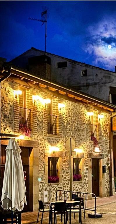a building with a table and chairs in front of it at Señorío de Santurde in Santurde