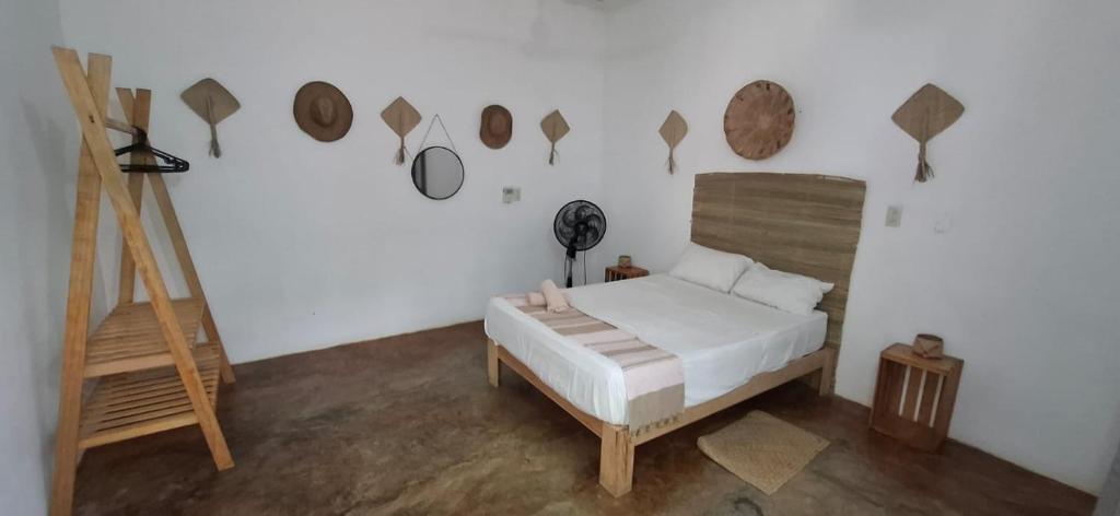 a bedroom with a bed and a wall with wooden accents at Flow De Lupe in Brisas de Zicatela