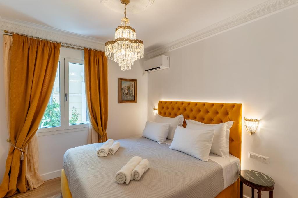 a bedroom with a bed with two towels on it at Athens Plaka Acropolis Suites in Athens