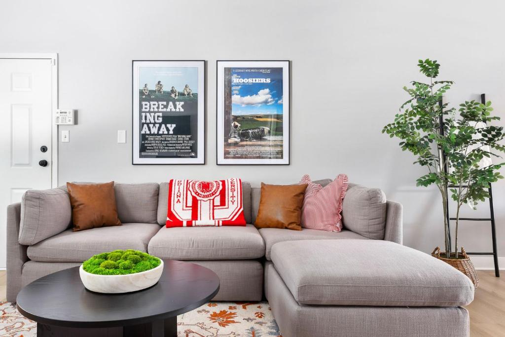 a living room with a couch and a table at Little 5 Condo King Beds Ping-pong Garage in Bloomington