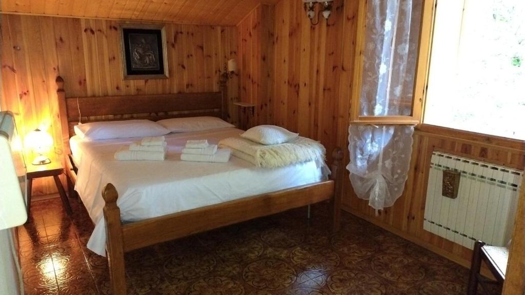 a bedroom with a bed in a wooden room at Appartamento Volturina in Fiumalbo