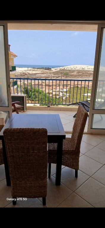 a table and chairs with a view of the beach at Pandora Ocena View II in Sal Rei