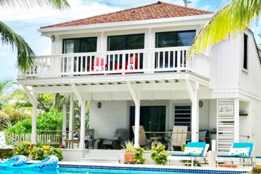 a house with a deck and a swimming pool at Holiday Time At Le Reve Beach House! in San Pedro
