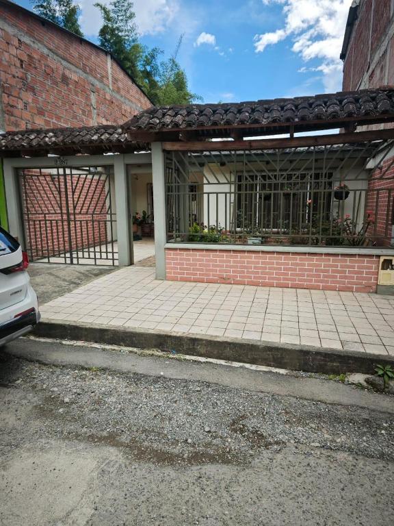 a brick building with a gate in front of it at Casa Descanso in Tunía