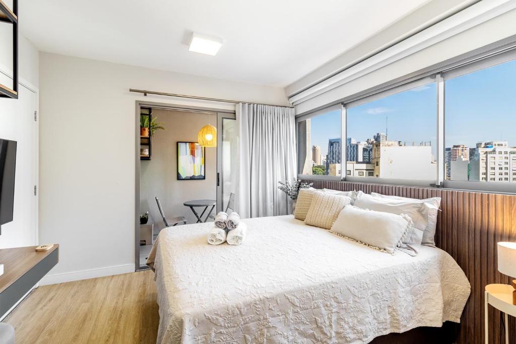 a bedroom with a bed and a large window at BSR Luxe Studio next to Allianz Park w Rooftop Pool and Pet Friendly in São Paulo