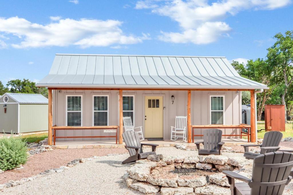 a tiny house with chairs and a fire pit at RusTx Ranch Unit 7- Music in Wimberley