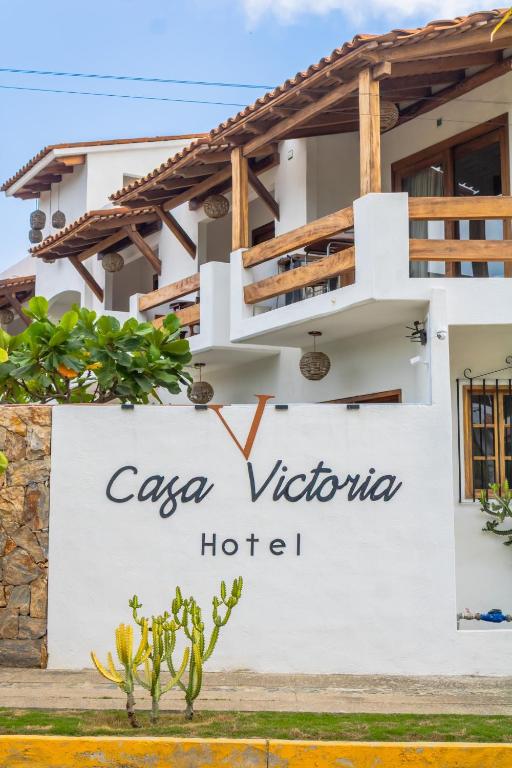a villa with a sign for a hotel at HOTEL CASA VICTORIA in Zihuatanejo